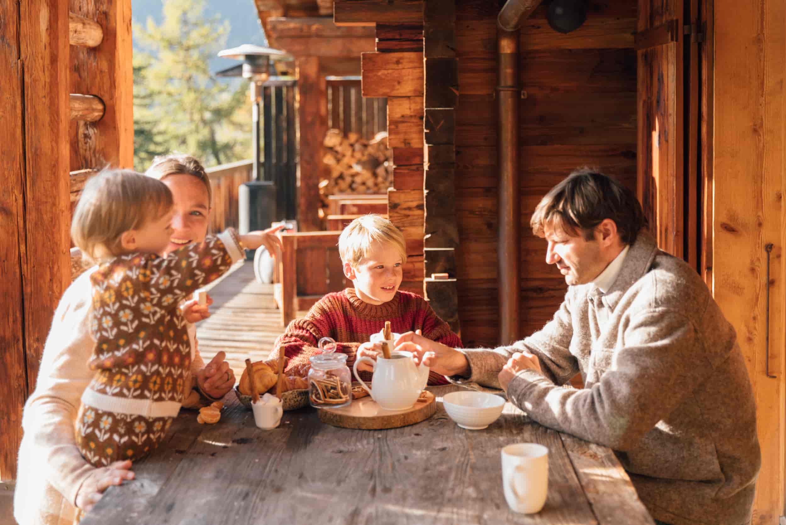 Family-gathered-on-terrace-enjoying-hot-chocolate