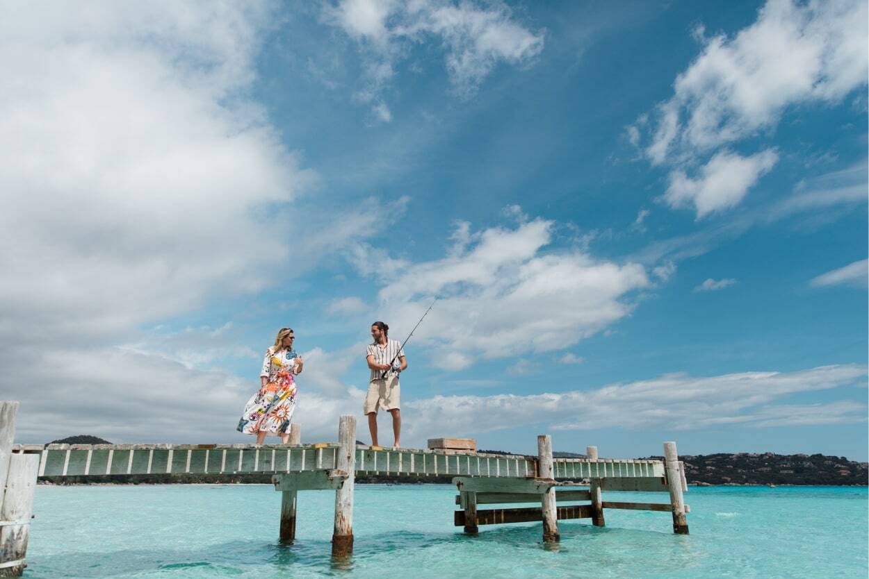 couple fishing at sea with turquoise waters