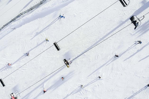 Birds eye view of skiiers and ski slopes