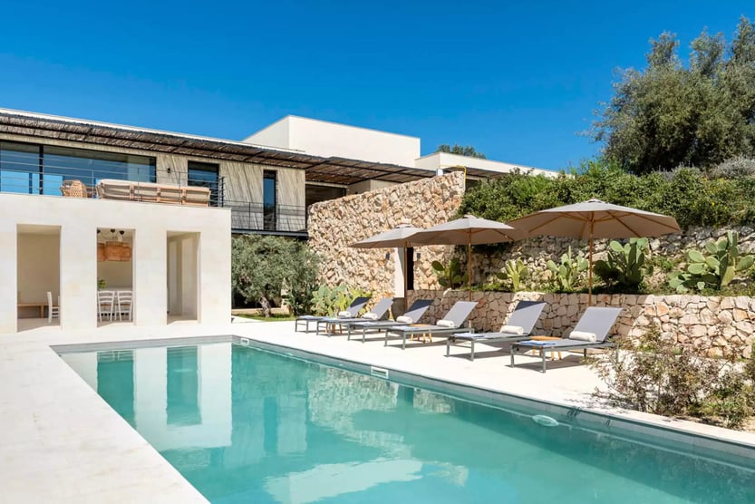 pool with lounger chairs at Villa Avolesi