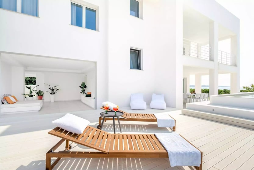 terrace of villa estate with wooden lounge chairs