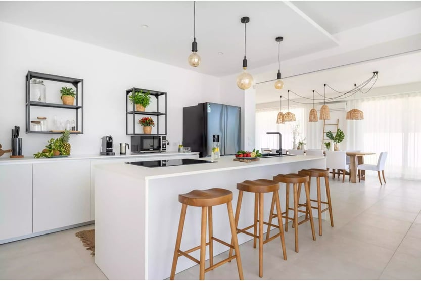 modern white kitchen at villa estate with warm wooden accents