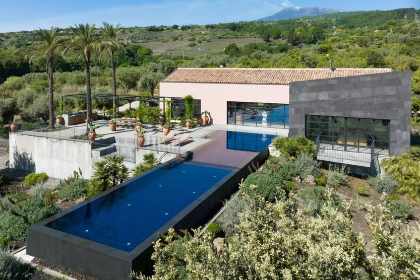 exterior of villa etna with pool and terrace surrounded by nature