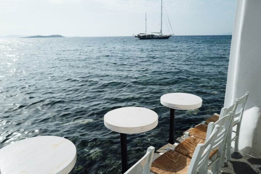 best-quiet-islands-greece-peaceful-holidays-sea-view-tables-mykonos