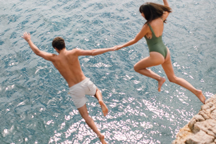 couple diving from cliff