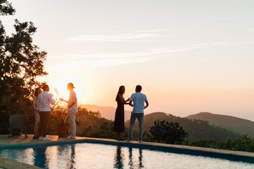 people by the pool with a view of nature in ibiza