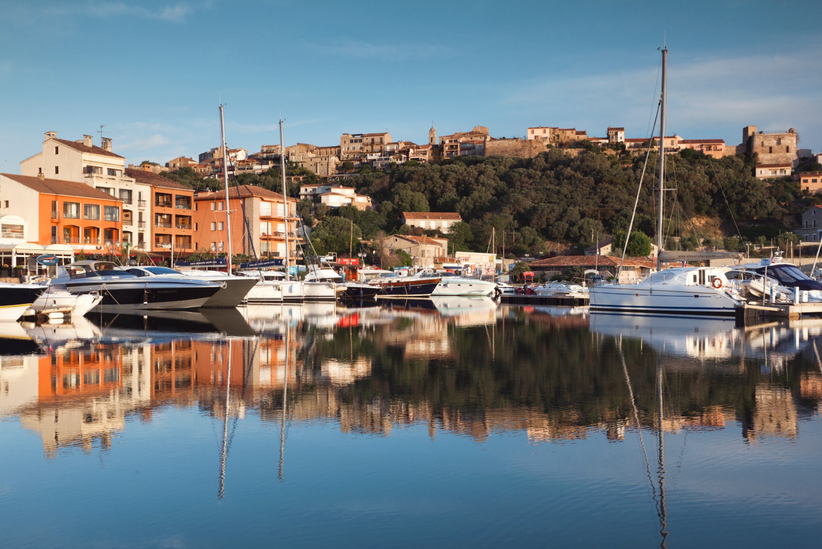 most-beautiful-towns-to-visit-in-corsica-porto-vecchio-port-boats-houses-sunset