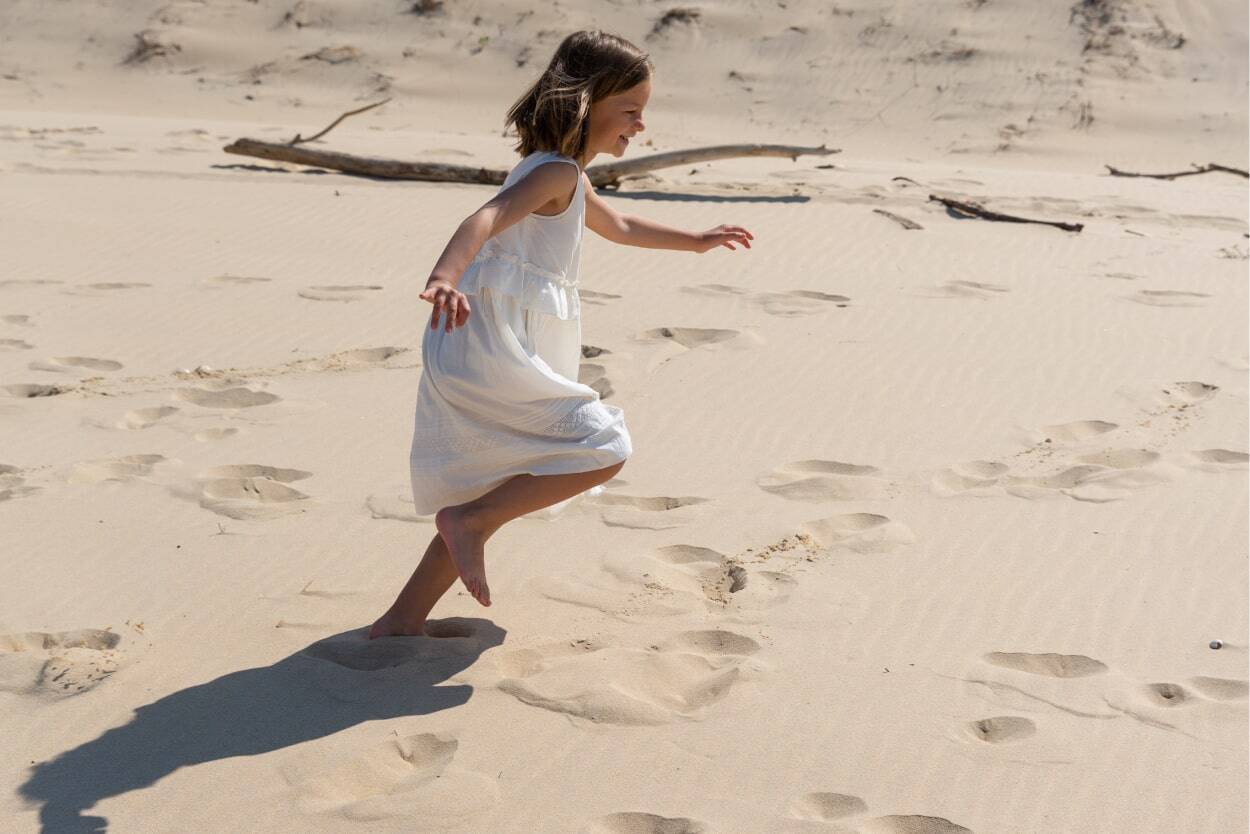 girl running on the sand in corsica