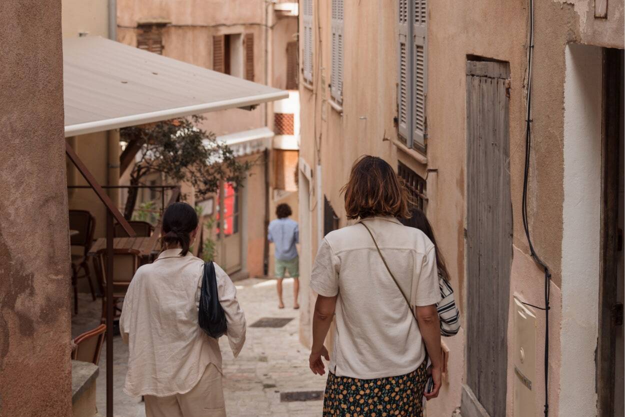 people walking in a village in corsica