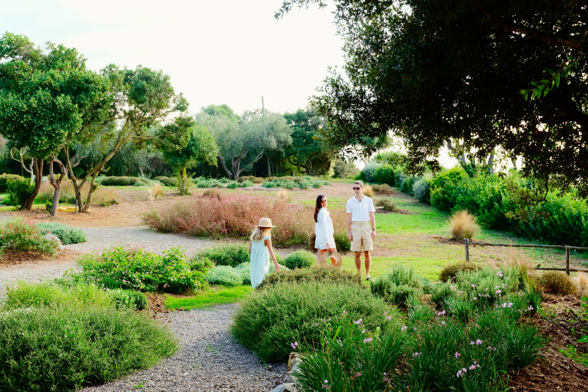 family surrounded by greenery outside in Tuscany