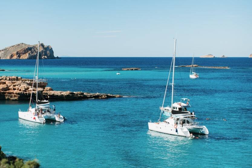 boats in turquoise waters in ibiza 