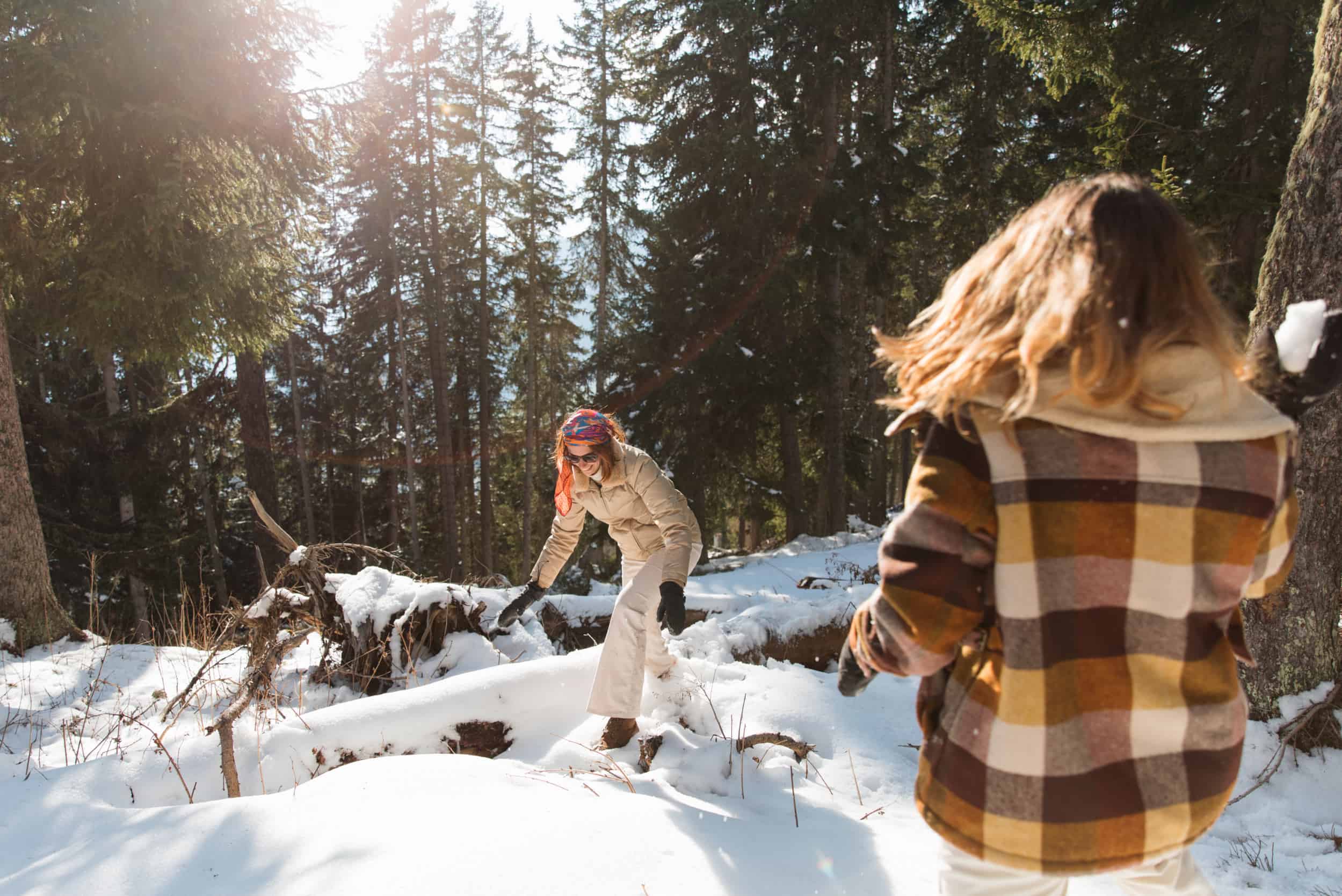 Two-women-playing-in-the-snow-in-a-forest-in-one-of-the-highest-ski-resorts-in-Europe