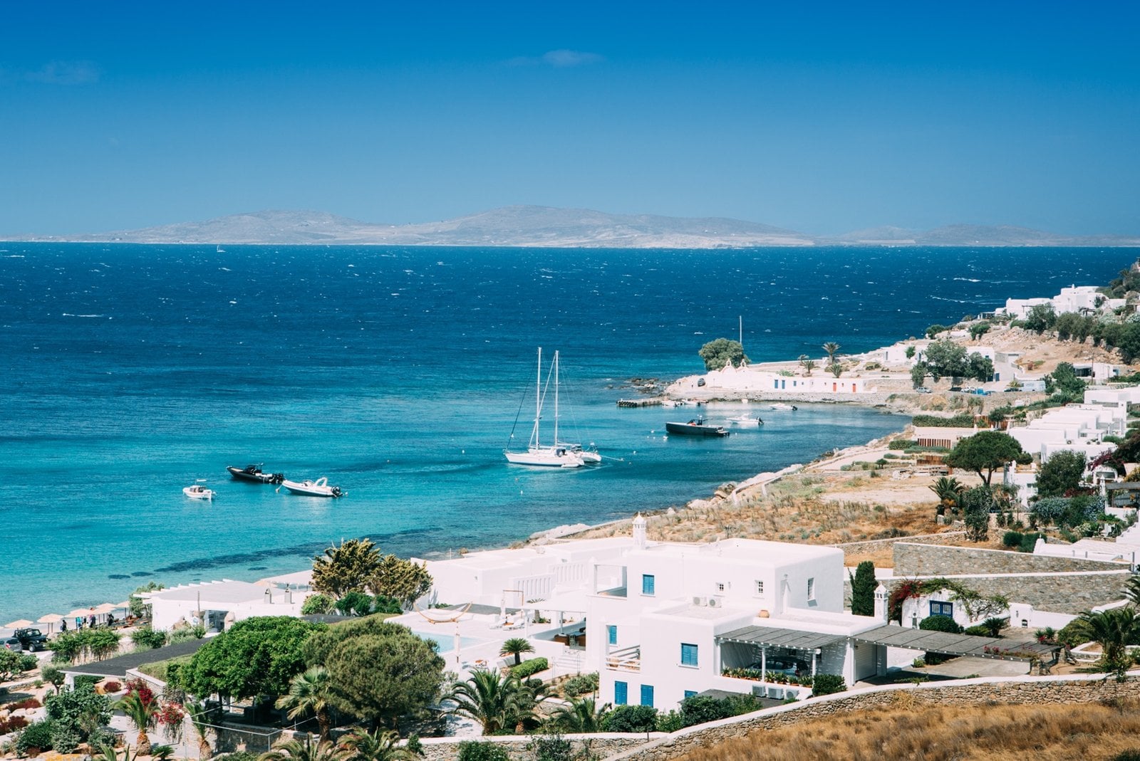 Whitewashed houses above a turquoise bay in the Cyclades, Greece