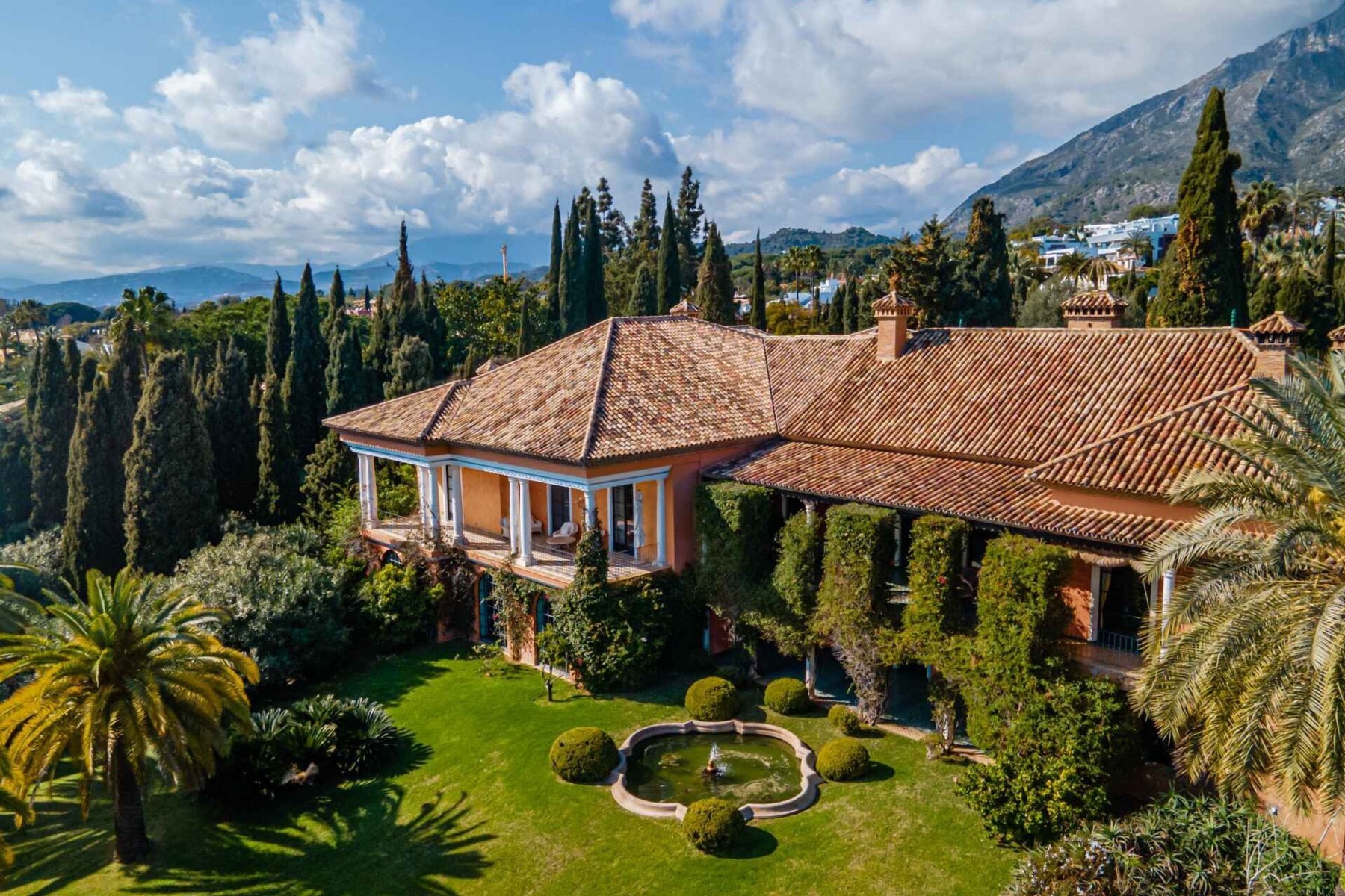 Villa Almedina and its gardens above Marbella, with the mountains beyond