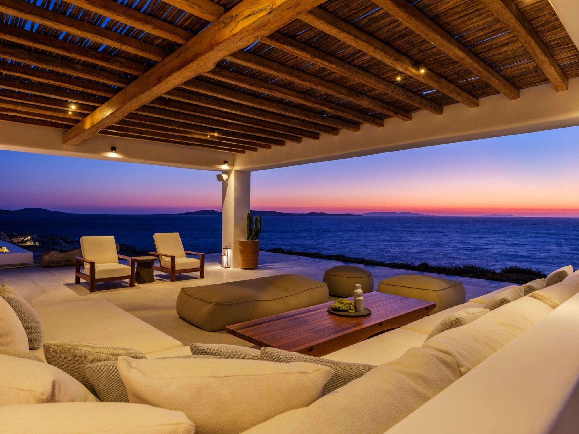 The covered terrace of Villa Amarea at sunset, overlooking the Aegean in Mykonos
