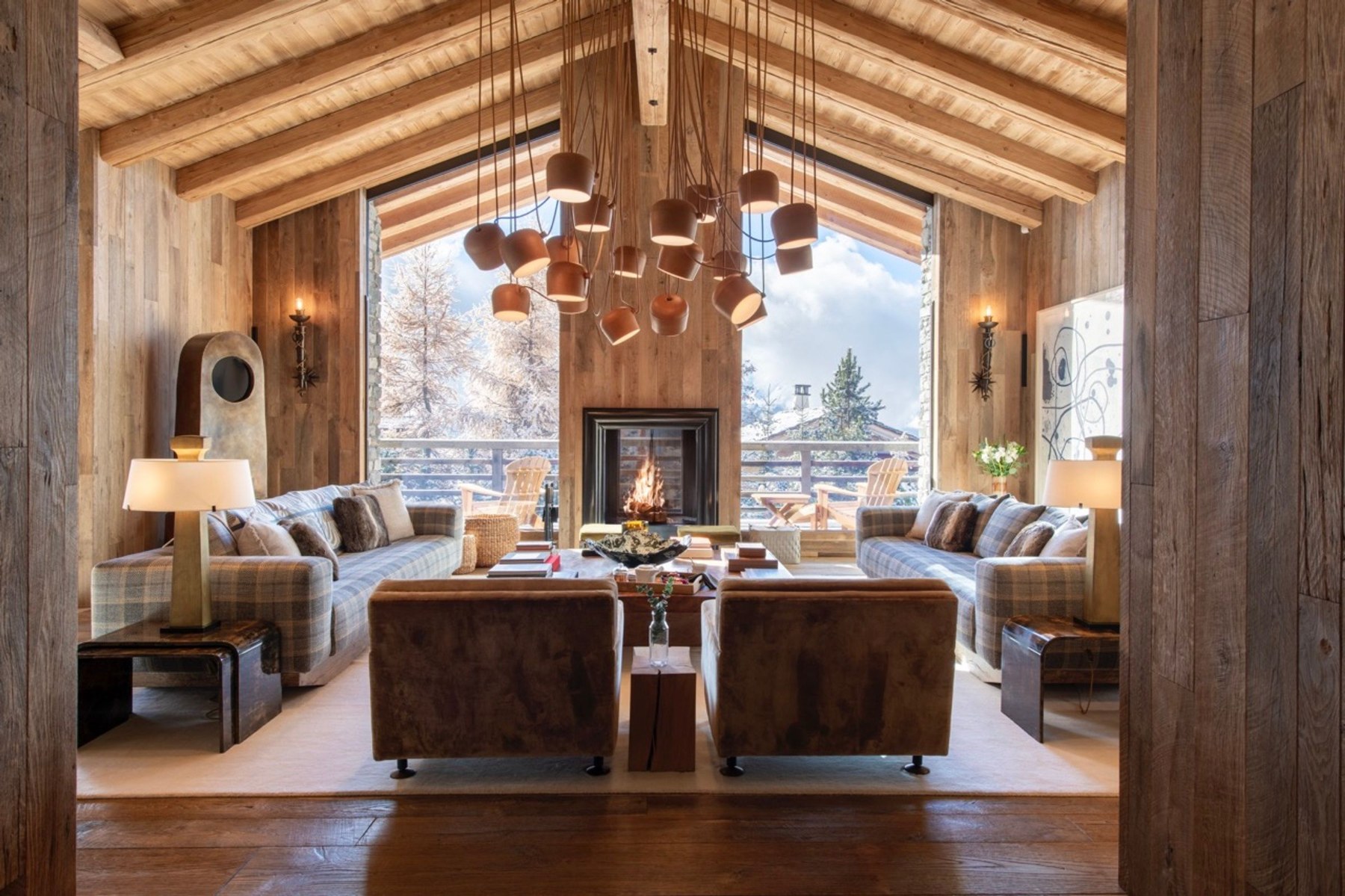The living room at Chalet Vicuña, with its central fireplace and views of the mountains