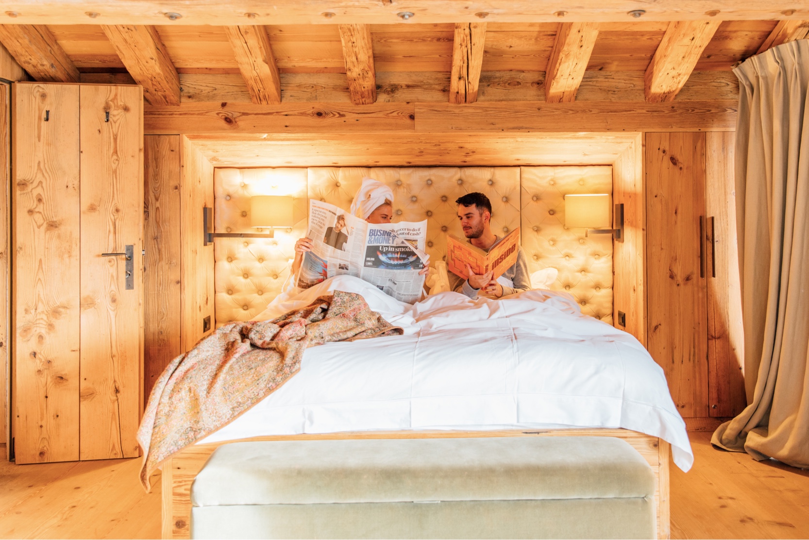 Breakfast served in bed in a wood-panelled chalet bedroom in Verbier