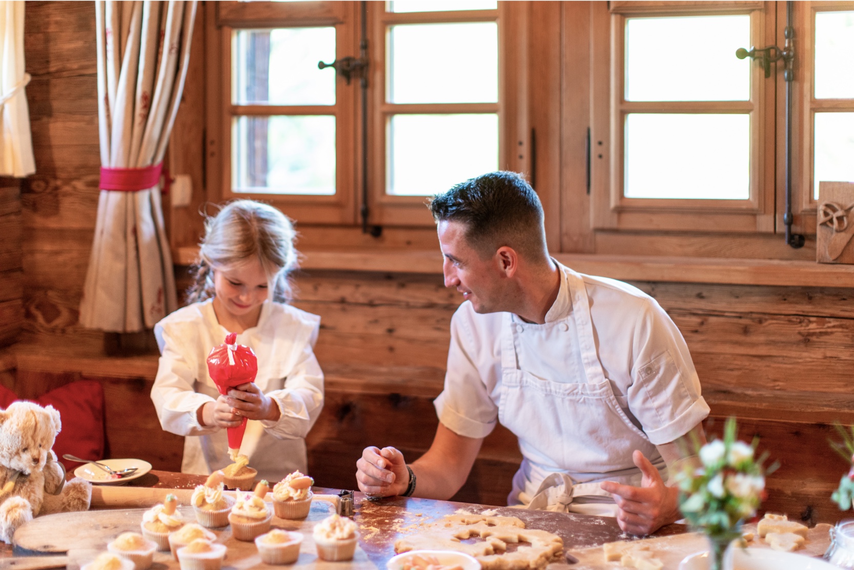 A private chef baking with a young guest in a Verbier chalet